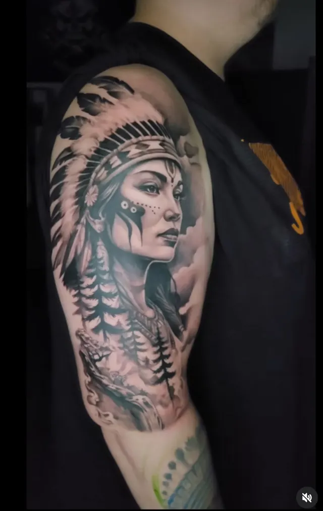 Realism portrait tattoo of a Native American woman in a feather headdress